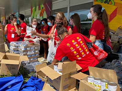 College students sort through boxes of canned goods